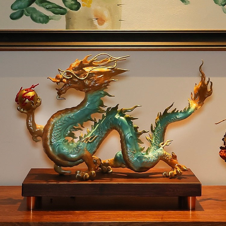 Left side view of the Chinese dragon statue, showcasing intricate detailing on its body and the golden ball.
