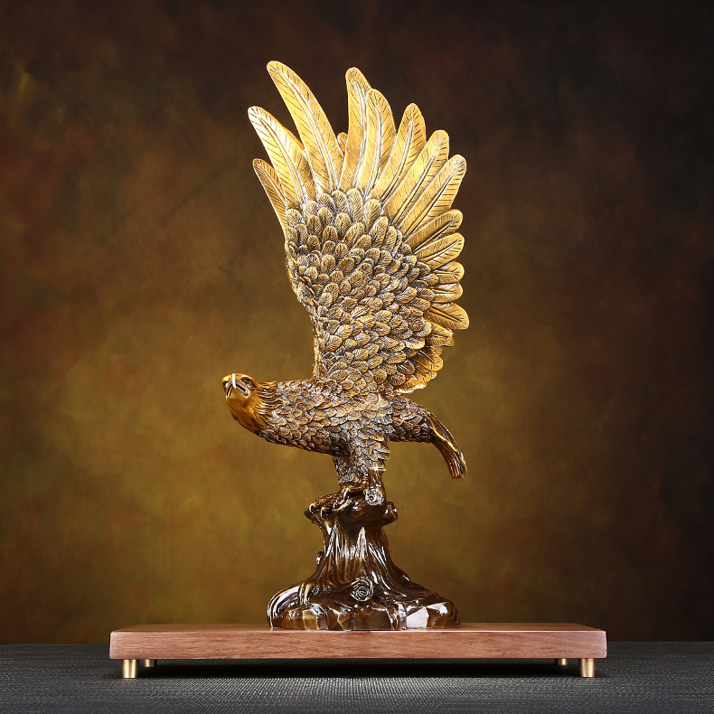 Majestic eagle figurine with intricate feather details, perched on a wooden base