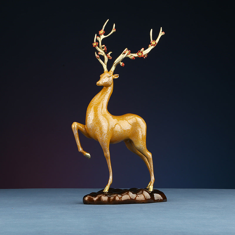 Side view of a golden deer figurine with blooming antlers, symbolizing elegance and good fortune.