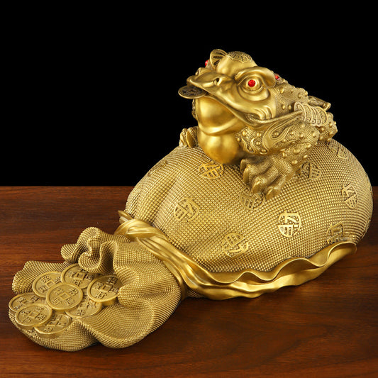 Front view of the golden toad, a feng shui ornament symbolizing wealth and prosperity.